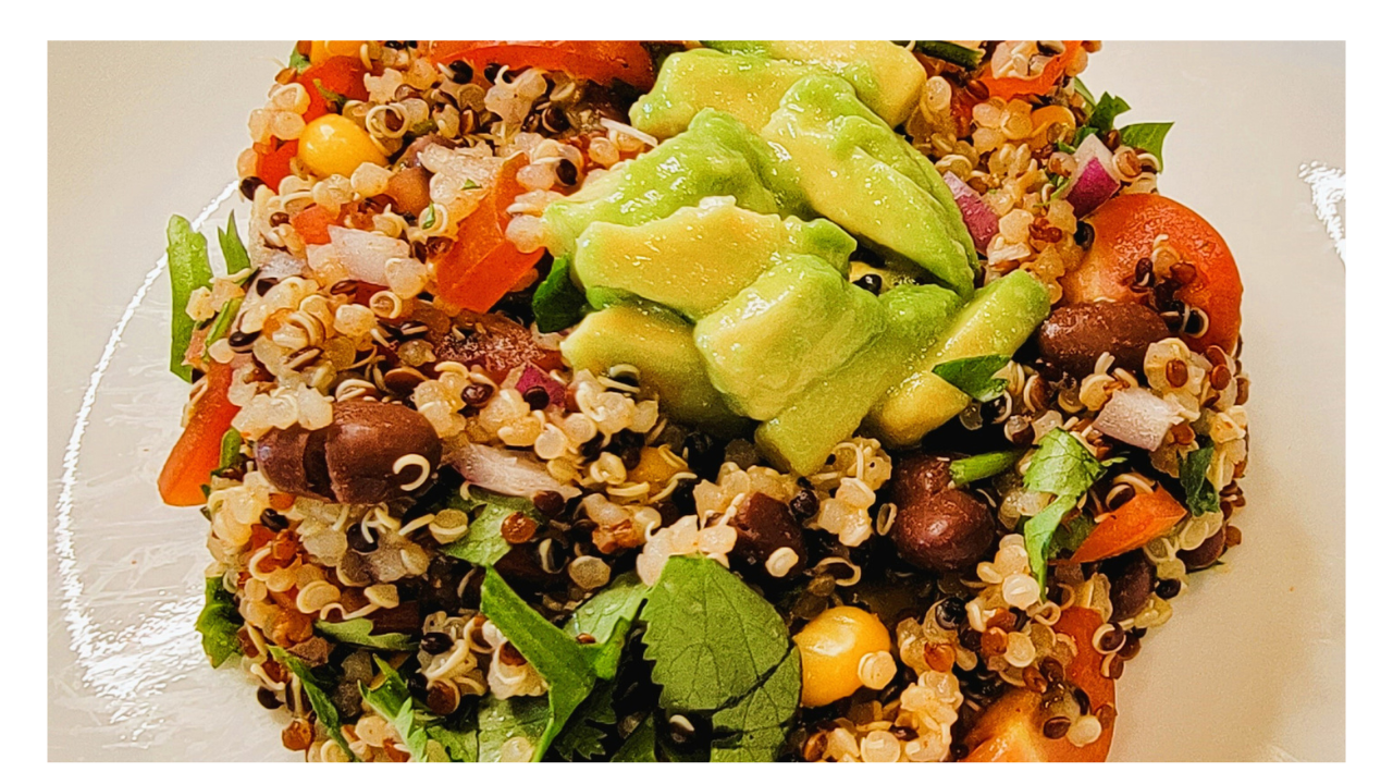 Quinoa and black bean salad topped with avocado